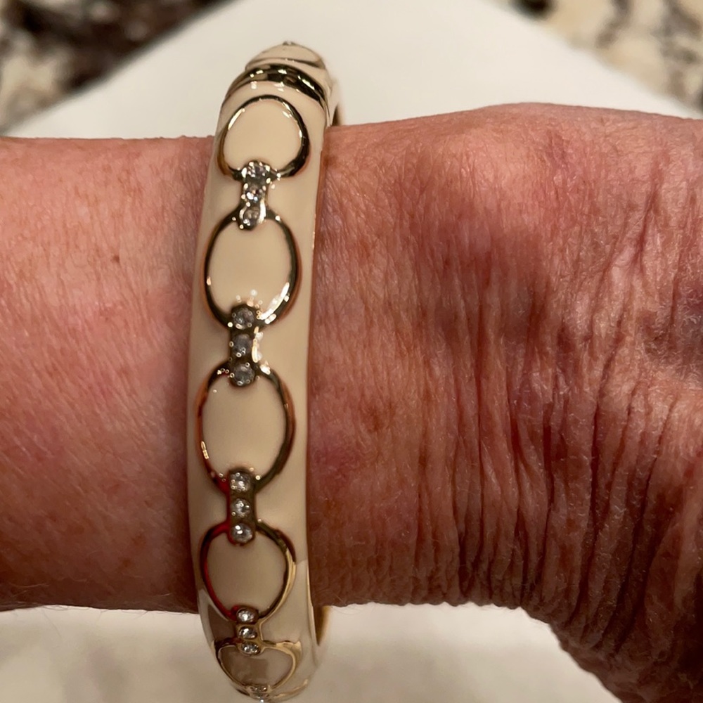 Cream and gold colored bangle bracelet